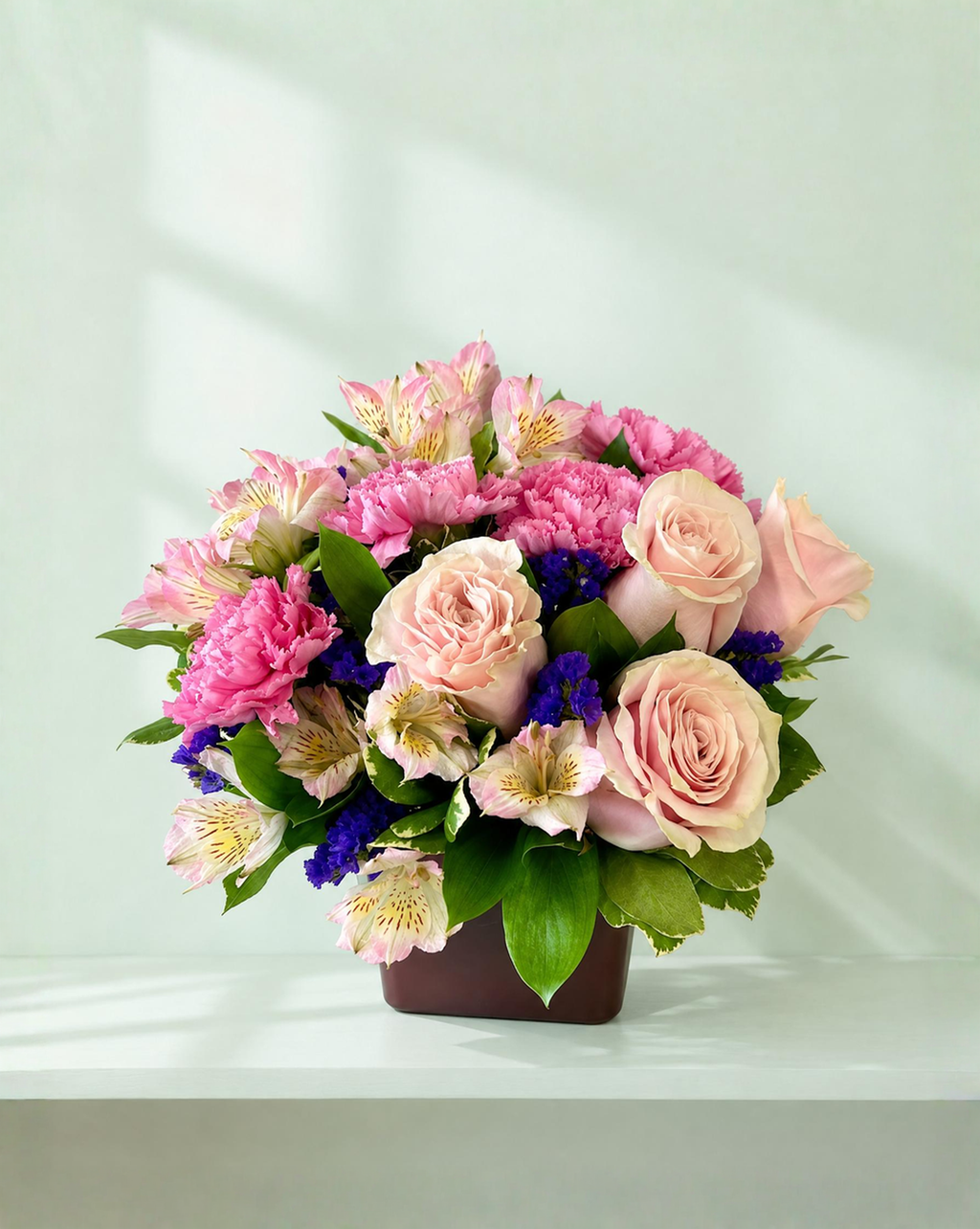 Lakewood Florist Beautiful Day bouquet featuring pink roses, carnations, and alstroemeria in a dark square vase.